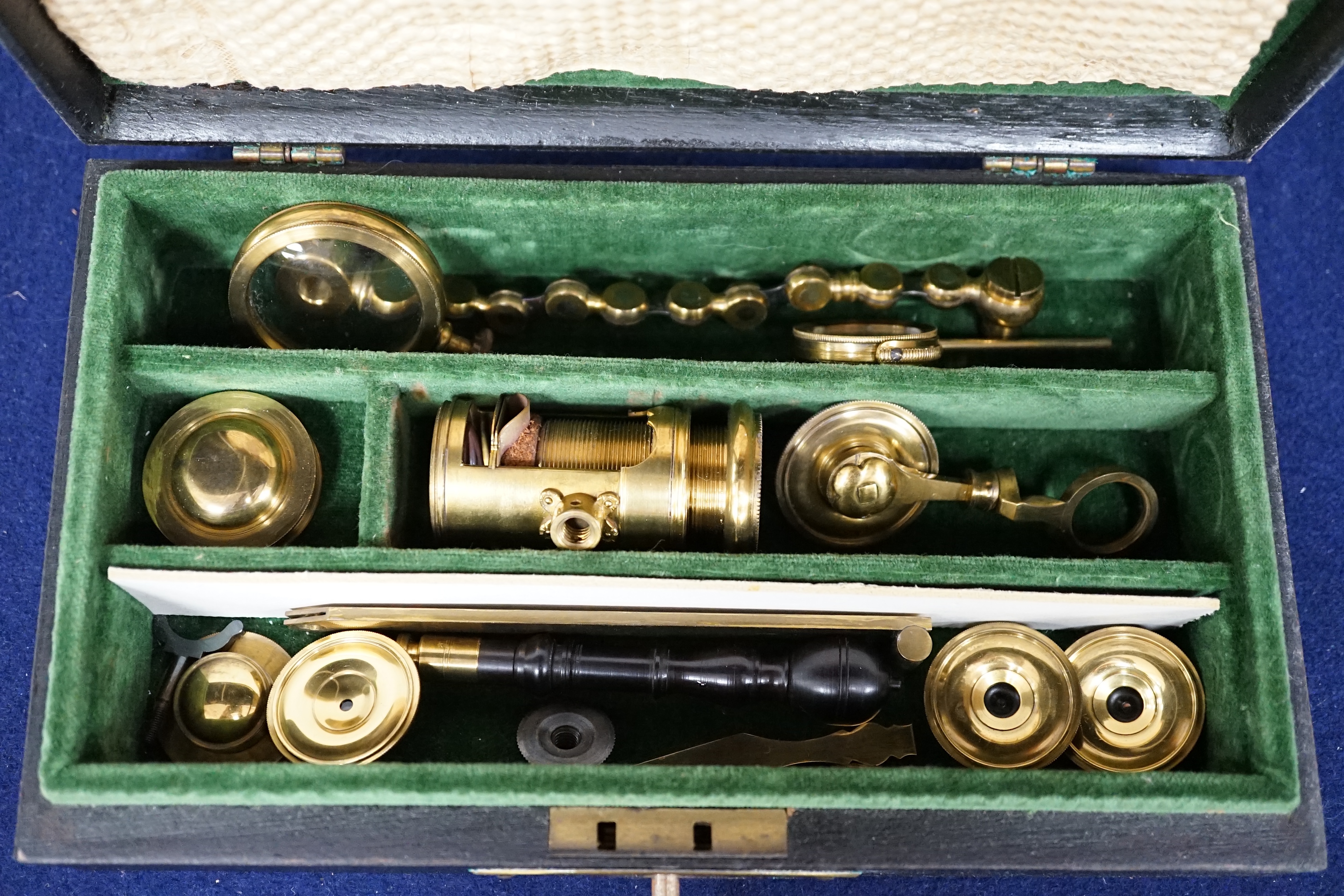 A case containing reproduction cylindrical microscope lenses and parts. Condition - fair.